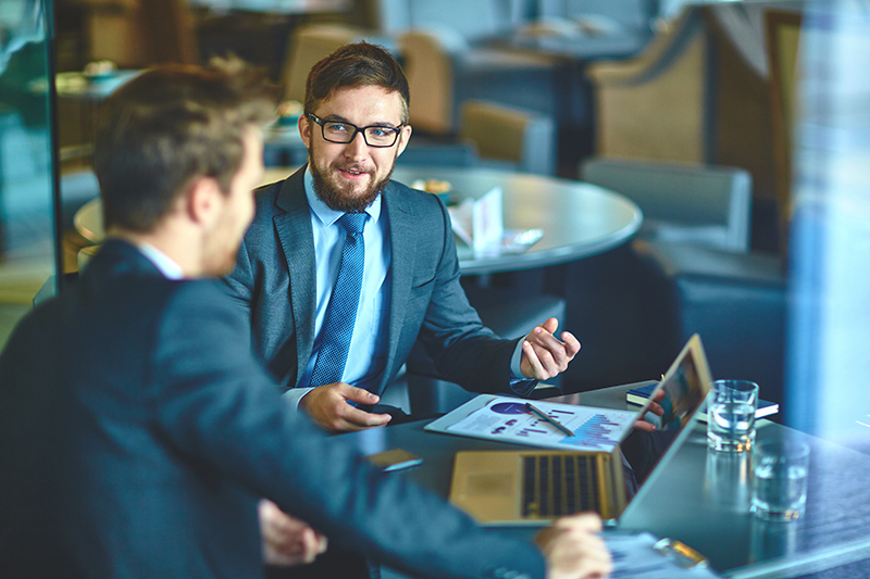 Young businessmen discussing ideas and strategies in office